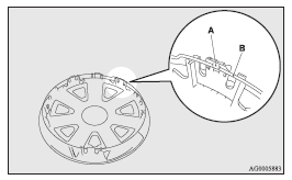 2. Align the tyre valve stem (C) with the cut out area (D) in the wheel cover.