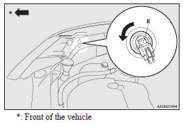 6. While holding down the tab (F), pull out the socket (G).