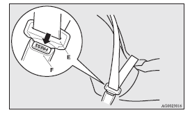 2. Push the button (G) on the buckle (C) using the latch plate (E) to disconnect