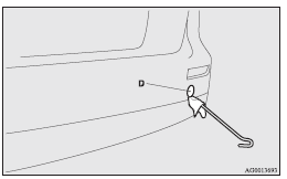 3. Use the wheel nut wrench (E) to firmly attach the towing hook (F).