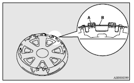 2. Align the air valve (C) of the tyre with the notch (D) in the wheel cover.